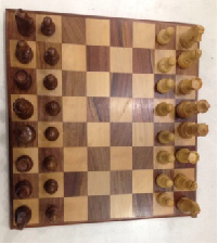 wood inlay chess flat with chessmen.